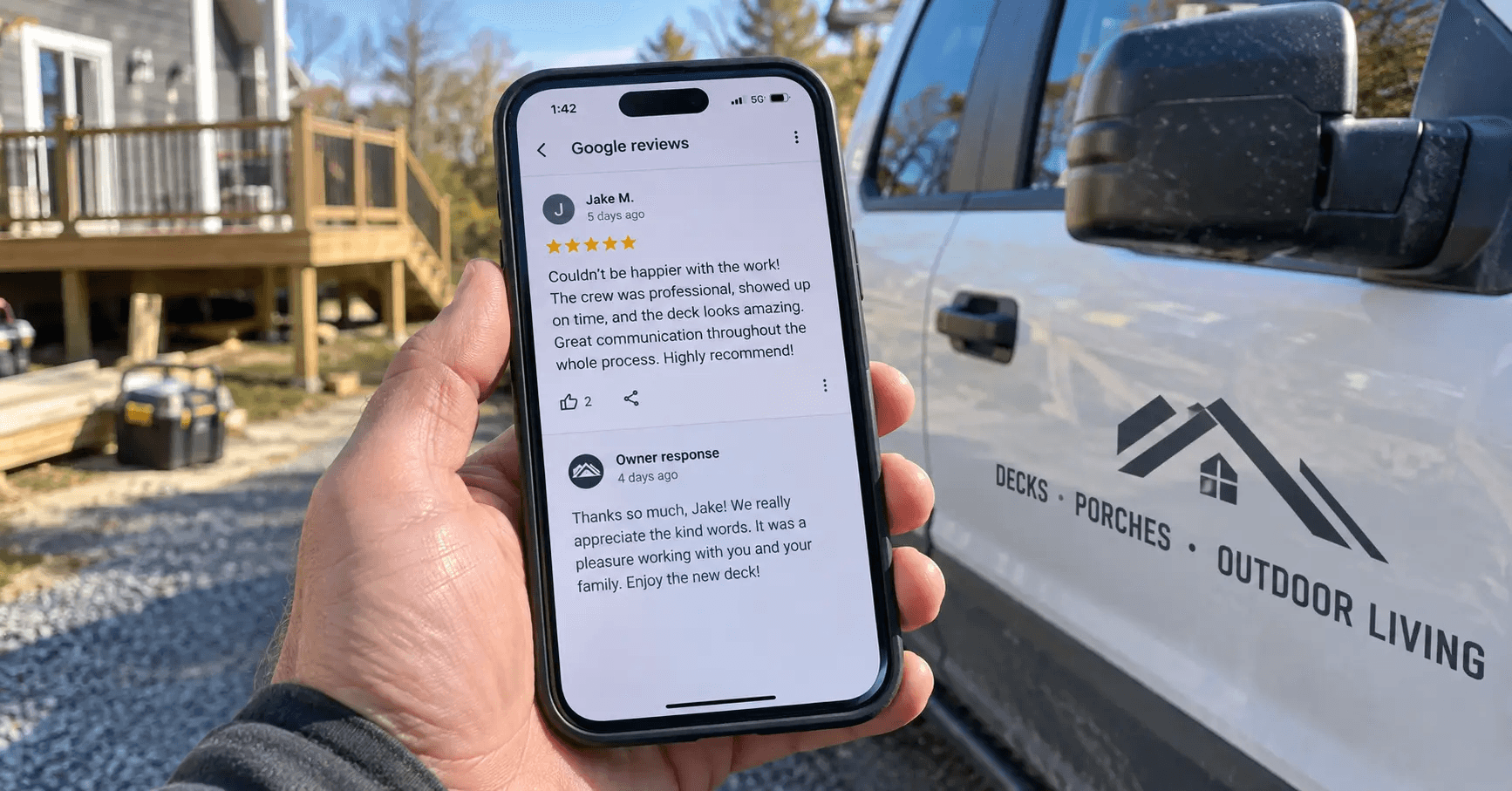 Contractor reading and replying to Google reviews on a phone in his work truck